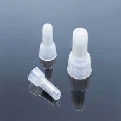 Three different sizes of nylon insulated close end wire connectors on dark reflective background, small medium large comparison